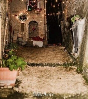 Un vicolo del borgo illuminato da lucine durante la festa